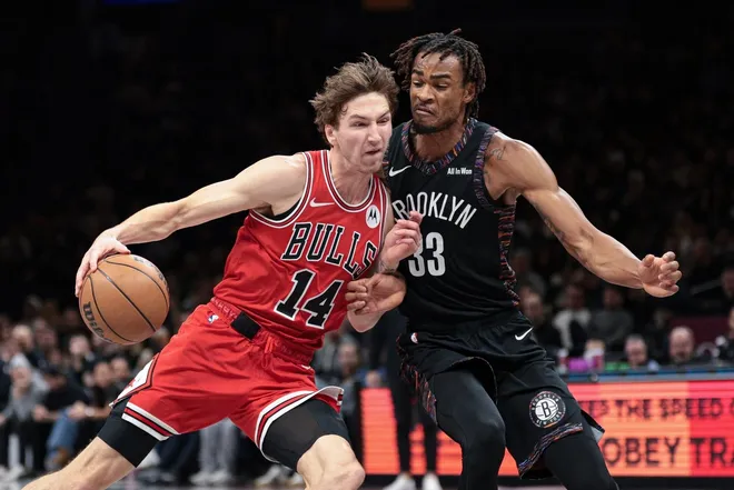 Jan 16, 2026; Brooklyn, New York, USA; Chicago Bulls forward Matas Buzelis (14) drives to the basket against Brooklyn Nets center Nic Claxton (33) during the second half at Barclays Center.