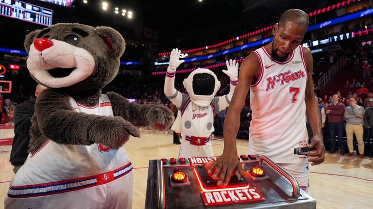 Houston Rockets forward Kevin Durant (7) presses a launch button...