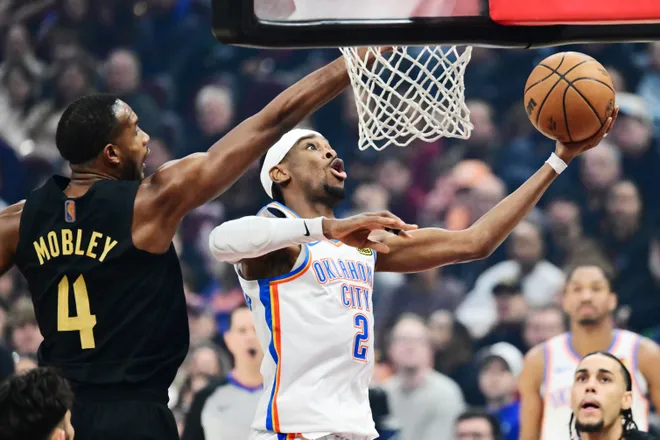Jan 19, 2026; Cleveland, Ohio, USA; Oklahoma City Thunder guard Shai Gilgeous-Alexander (2) drives to the basket against Cleveland Cavaliers center Evan Mobley (4) during the first quarter at Rocket Arena. Mandatory Credit: Ken Blaze-Imagn Images