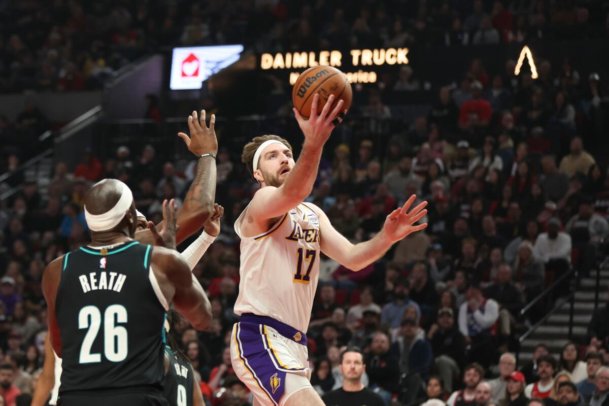 Lakers forward Drew Timme drives to the basket in front of Portland Trail Blazers center Duop Reath on Jan. 17.