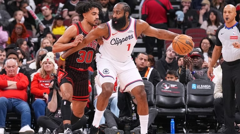 LA Clippers guard James Harden, right, drives as Chicago Bulls...