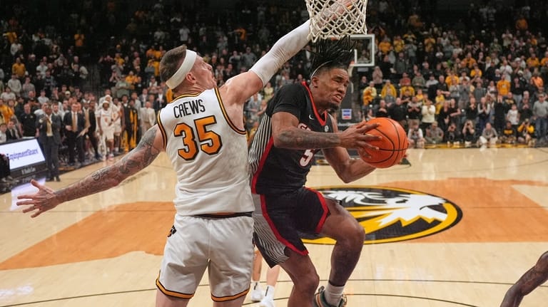 Georgia's Jeremiah Wilkinson (5) heads to the basket as Missouri's...