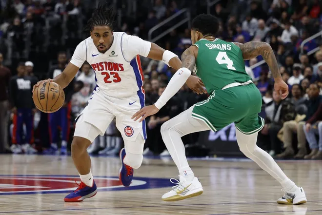 Jan 19, 2026; Detroit, Michigan, USA; Detroit Pistons guard Jaden Ivey (23) drives against Boston Celtics guard Derrick White (9) in the second half at Little Caesars Arena.