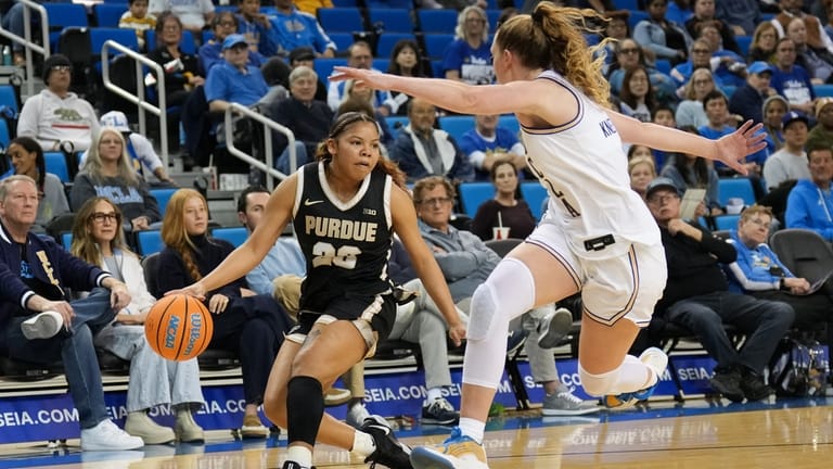 Purdue guard Kiki Smith (23) drives under pressure by UCLA...