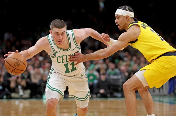 Boston Celtics guard Payton Pritchard (11) tries to get around Indiana Pacers guard Andrew Nembhard during the first half. (Photo By Matt Stone/Boston Herald)