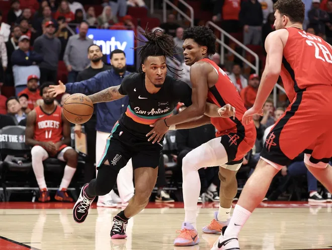 Jan 20, 2026; Houston, Texas, USA;San Antonio Spurs guard Stephon Castle (5) dribbles against Houston Rockets guard Amen Thompson (1) in the second half at Toyota Center.