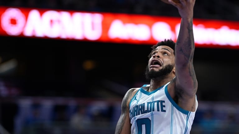 Charlotte Hornets forward Miles Bridges (0) goes up to shoot...