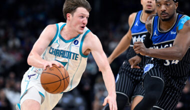 Charlotte Hornets guard Kon Knueppel, left, drives to the basket as Orlando Magic center Wendell Carter Jr., right, and forward Noah Penda, second from right, defend during the first half of an NBA basketball game, Thursday, Jan. 22, 2026, in Orlando, Fla. (AP Photo/Phelan M. Ebenhack)
