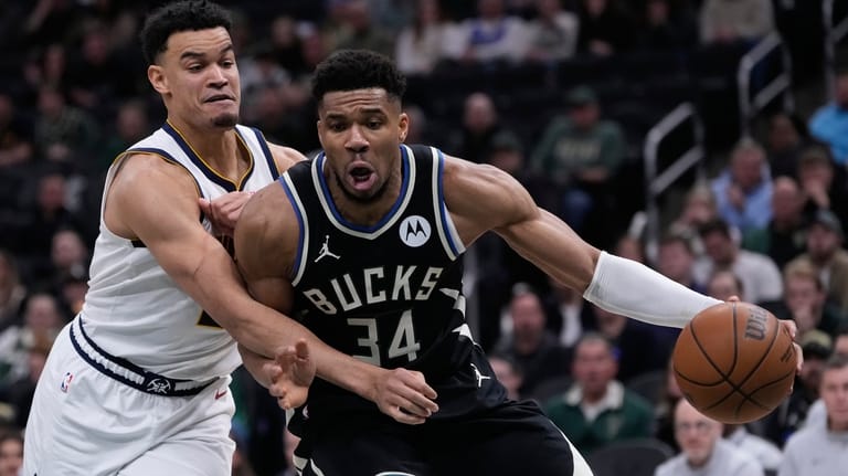 Milwaukee Bucks' Giannis Antetokounmpo (34) tries to get past Denver...