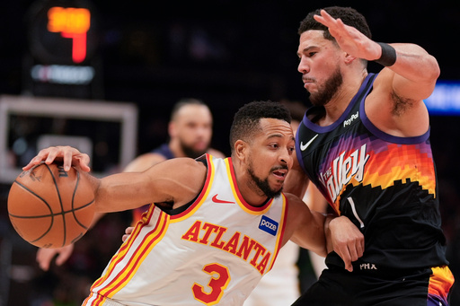 Suns' Devin Booker exits with right ankle injury vs. Hawks