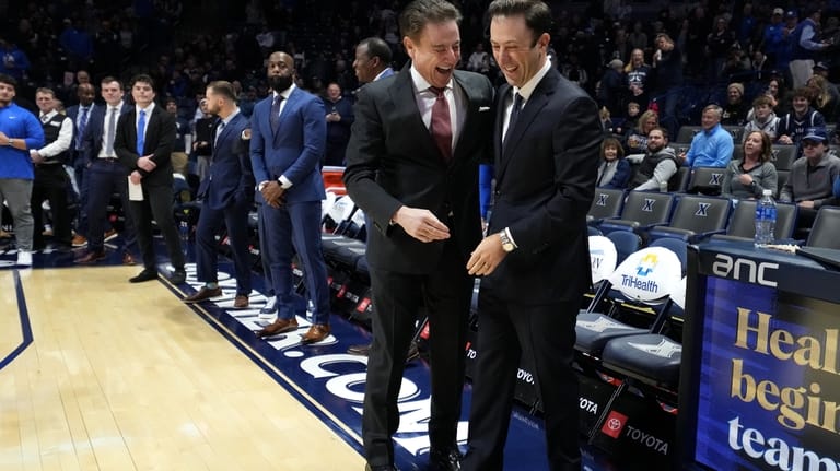 St. John's head coach Rick Pitino, left, and Xavier head...