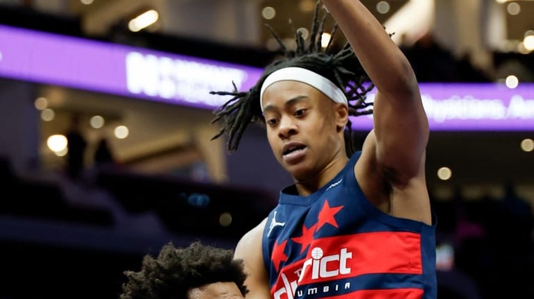 Charlotte Hornets forward Miles Bridges, left, passes against Washington Wizards...