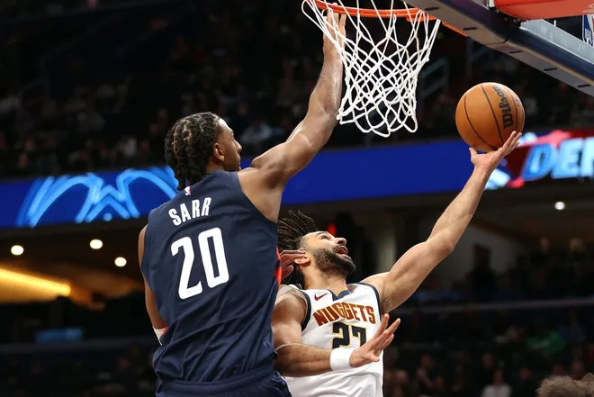 Jan 22, 2026; Washington, District of Columbia, USA; Denver Nuggets guard Jamal Murray (27) shoots over Washington Wizards center Alex Sarr (20) during the second half at Capital One Arena.