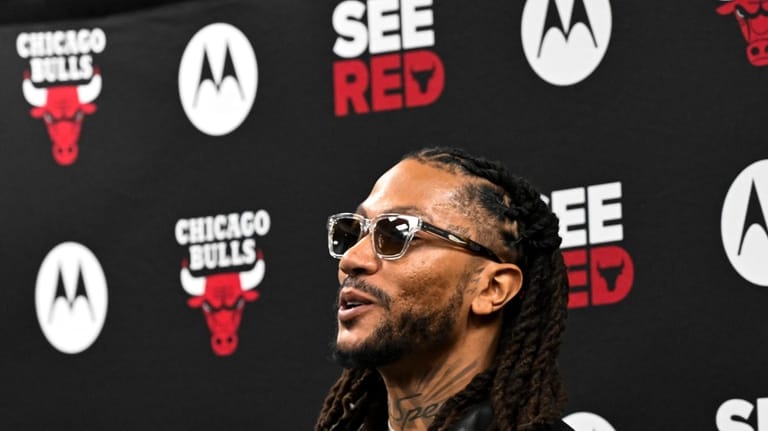 Former Chicago Bulls player Derrick Rose, smiles after a press...