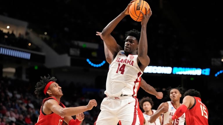 Alabama center Charles Bediako (14) pulls down a rebound while...