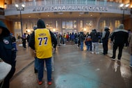People wait for the door to open before an NBA basketball game between the Dallas Mavericks...