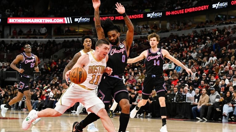 Boston Celtics guard Payton Pritchard (11) drives against Chicago Bulls...