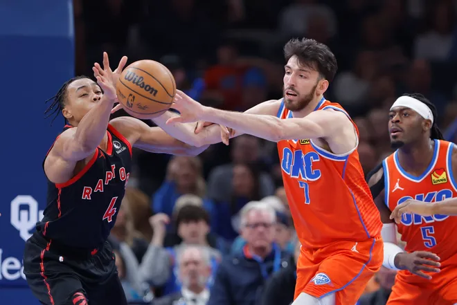Jan 25, 2026; Oklahoma City, Oklahoma, USA; Toronto Raptors forward/guard Scottie Barnes (4) and Oklahoma City Thunder center/forward Chet Holmgren (7) reach for a loose ball during the second half at Paycom Center. Mandatory Credit: Alonzo Adams-Imagn Images