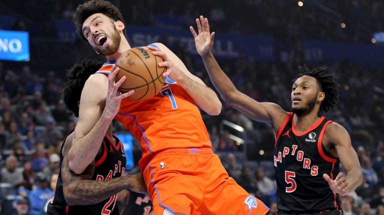 Oklahoma City Thunder center Chet Holmgren (7) works to get...