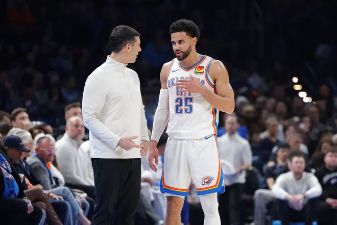 Jan 7, 2026; Oklahoma City, Oklahoma, USA; Oklahoma City Thunder guard Ajay Mitchell (25) talks to Oklahoma City Thunder Head Coach Mark Daigneault during a break in play against the Utah Jazz during the second quarter at Paycom Center. Mandatory Credit: Alonzo Adams-Imagn Images
