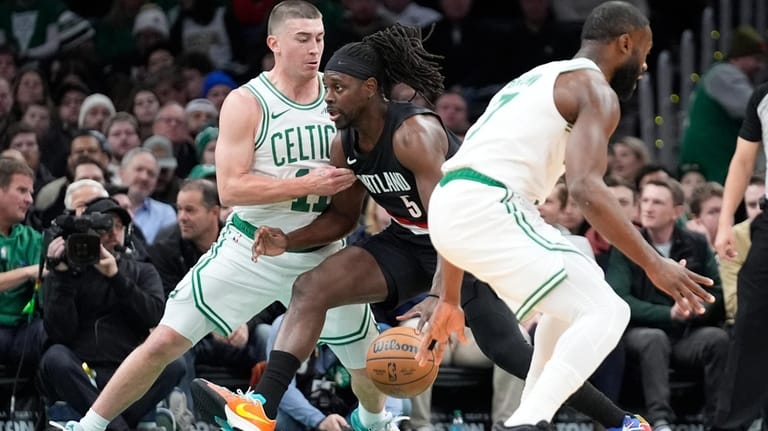 Portland Trail Blazers guard Jrue Holiday (5) drives to the...