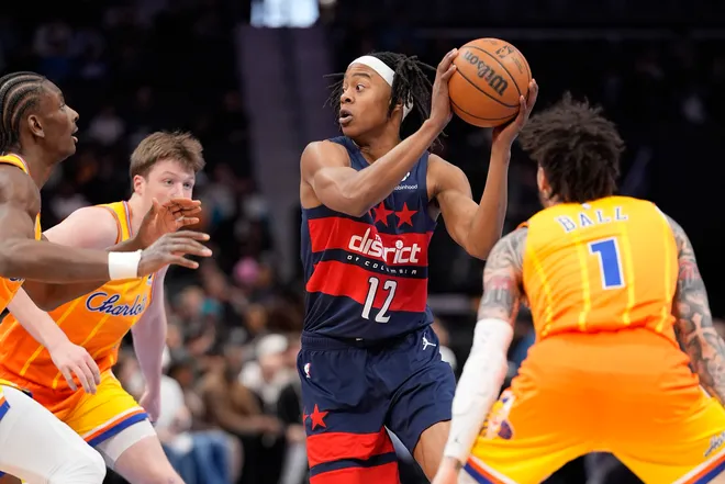 Jan 24, 2026; Charlotte, North Carolina, USA; Washington Wizards guard Tre Johnson (12) looks to pass surrounded by Hornets defenders during the first quarter at the Spectrum Center. Mandatory Credit: Jim Dedmon-Imagn Images