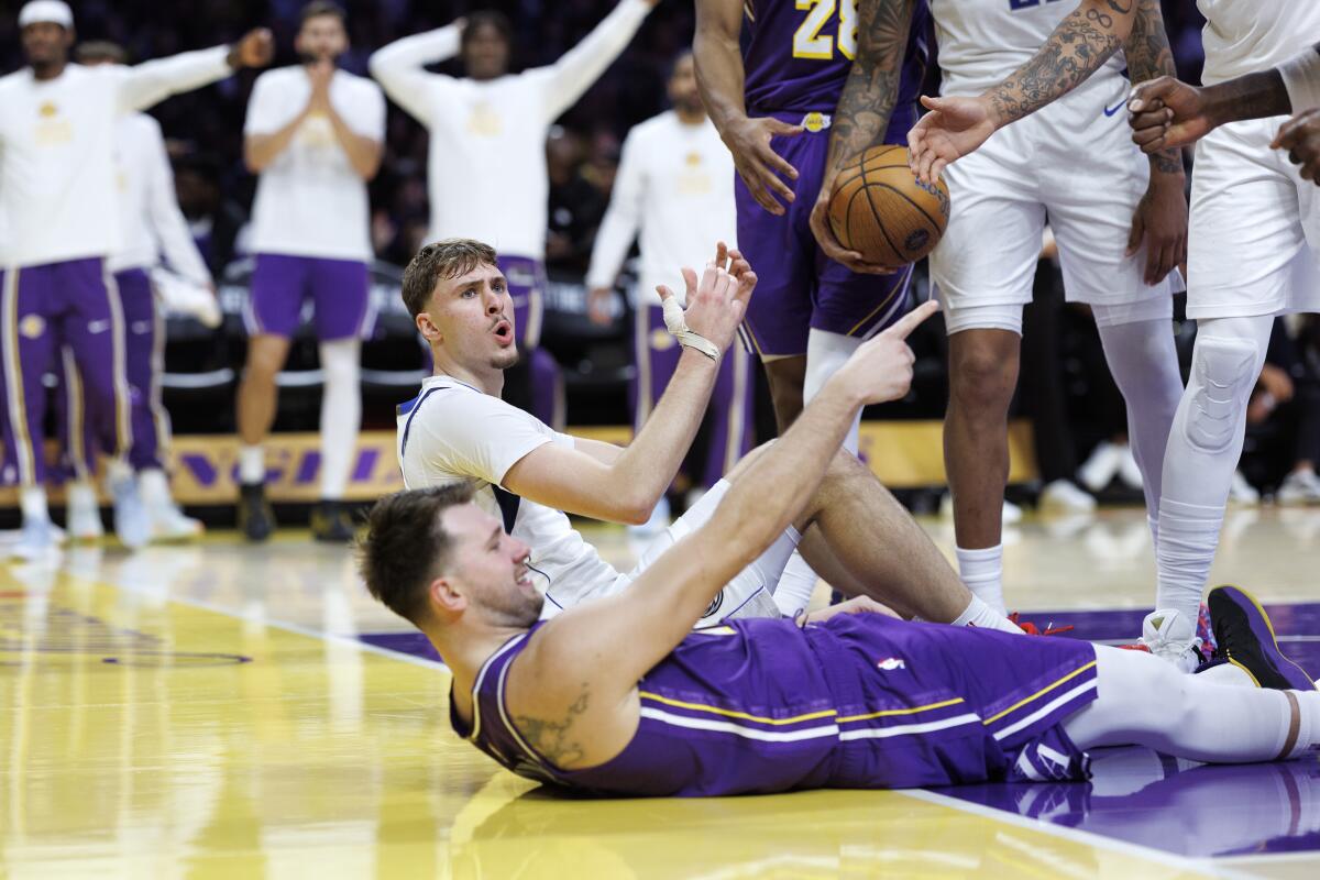 Luka Doncic points after taking a charge from Dallas' Cooper Flagg earlier this season.