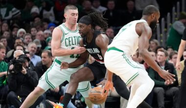 Holiday returns to cheers from Boston fans who braved a snow storm to see the Celtics beat the Blazers 102-94