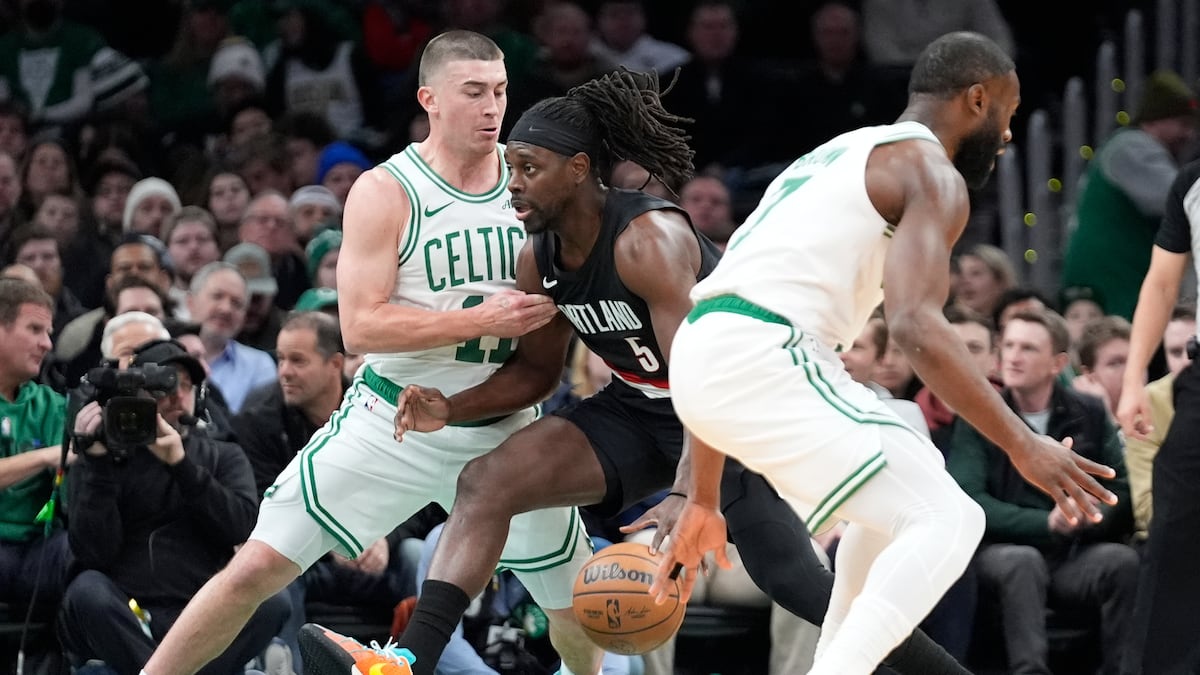 Holiday returns to cheers from Boston fans who braved a snow storm to see the Celtics beat the Blazers 102-94