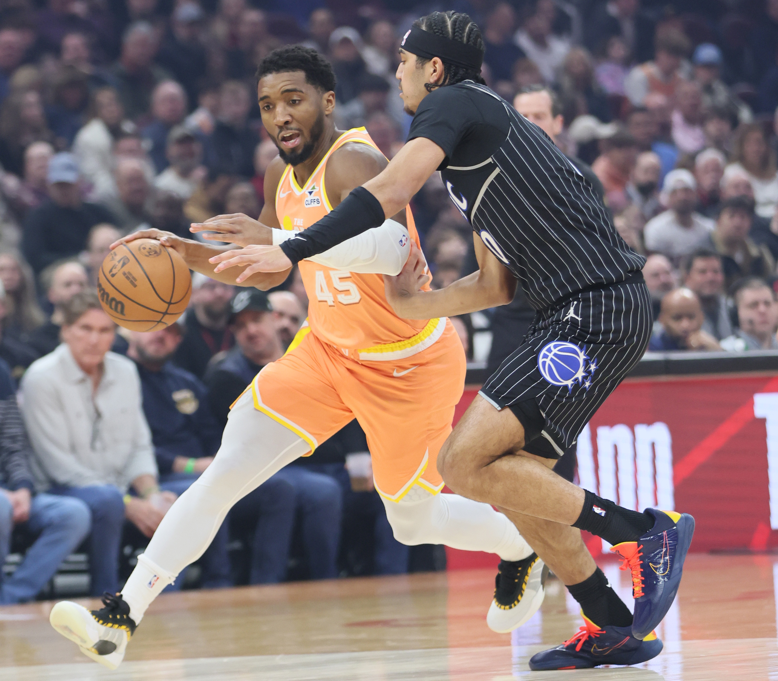 Cleveland Cavaliers guard Donovan Mitchell starts a drive towards the basket guarded by Orlando Magic guard Anthony Black in the first half at Rocket Arena. 