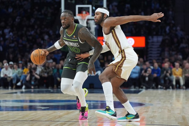Minnesota Timberwolves forward Julius Randle (30) works toward the basket as Golden State Warriors guard Buddy Hield, right, defends during the first half of an NBA basketball game, Monday, Jan. 26, 2026, in Minneapolis. (AP Photo/Abbie Parr)