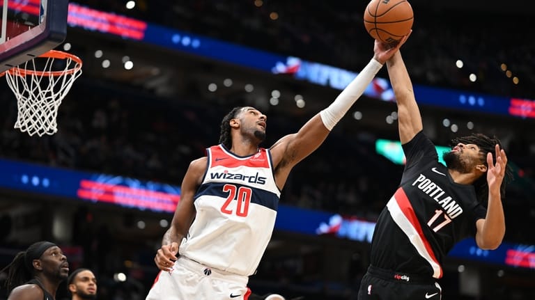Washington Wizards center Alex Sarr (20) competes for a rebound...