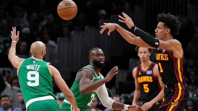 Atlanta Hawks forward Jalen Johnson (1) passes over Boston Celtics...