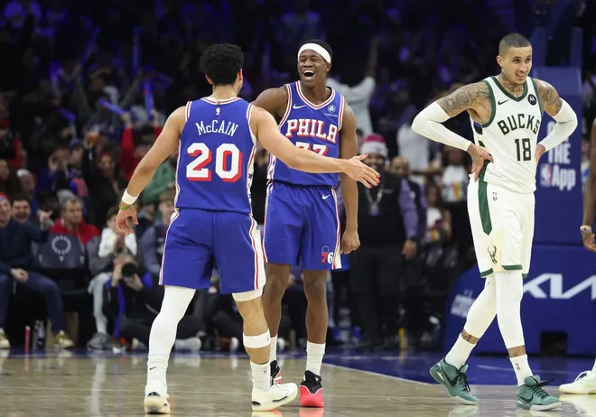 Jan 27, 2026; Philadelphia, Pennsylvania, USA; Philadelphia 76ers guard Vj Edgecombe (77) reacts to guard Jared McCain (20) three pointer in front of Milwaukee Bucks forward Kyle Kuzma (18) during the fourth quarter at Xfinity Mobile Arena.