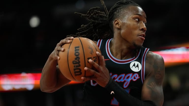 Chicago Bulls guard Ayo Dosunmu handles the ball during the...