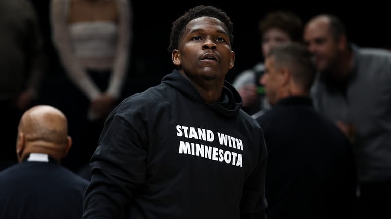 Minnesota Timberwolves guard Anthony Edwards looks on while wearing a...