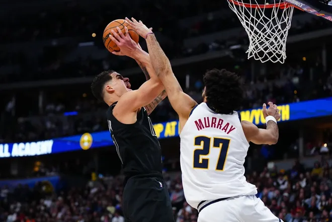 Jan 29, 2026; Denver, Colorado, USA; Brooklyn Nets forward Michael Porter Jr. (17) shoots the ball over Denver Nuggets guard Jamal Murray (27) in the second half at Ball Arena.