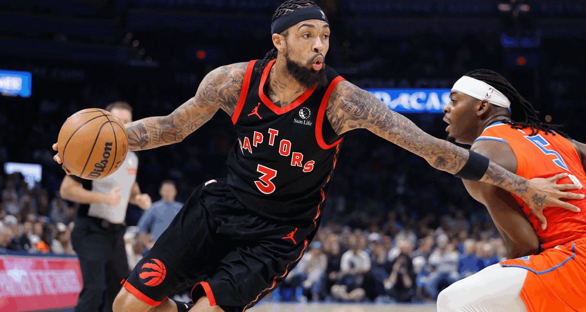 Brandon Ingram (3) dribbles past an Oklahoma City defender.