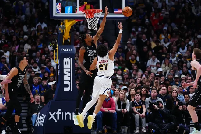 Jan 29, 2026; Denver, Colorado, USA; Denver Nuggets guard Jamal Murray (27) shoots the ball at Brooklyn Nets center Nic Claxton (33) in the third quarter at Ball Arena.