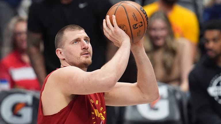 Denver Nuggets center Nikola Jokić warms up before an NBA...