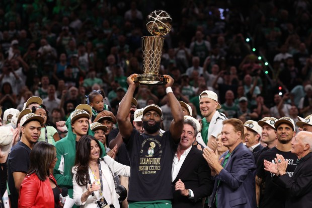 Jaylen Brown #7 of the Boston Celtics holds up the Larry O'Brien trophy after Boston's 106-88 win against the Dallas Mavericks in Game Five of the 2024 NBA Finals at TD Garden on June 17, 2024 in Boston, Massachusetts. NOTE TO USER: User expressly acknowledges and agrees that, by downloading and or using this photograph, User is consenting to the terms and conditions of the Getty Images License Agreement. (Photo by Elsa/Getty Images)