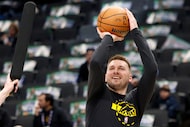 Los Angeles Lakers guard Luka Doncic, center, warms up before an NBA basketball game against...