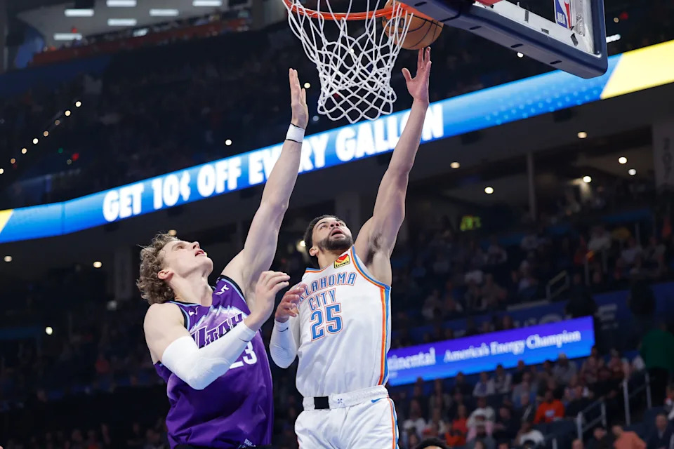 Jan 7, 2026; Oklahoma City, Oklahoma, USA; Oklahoma City Thunder guard Ajay Mitchell (25) goes up for a basket beside Utah Jazz forward/center Lauri Markkanen (23) during the second quarter at Paycom Center. Mandatory Credit: Alonzo Adams-Imagn Images