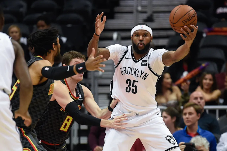 Dec 4, 2017; Atlanta, GA, USA; Brooklyn Nets forward Trevor Booker (35) reaches to control the ball against Atlanta Hawks forward Luke Babbitt (8) and forward DeAndre' Bembry (95) during the first half at Philips Arena. Mandatory Credit: Dale Zanine-USA TODAY Sports