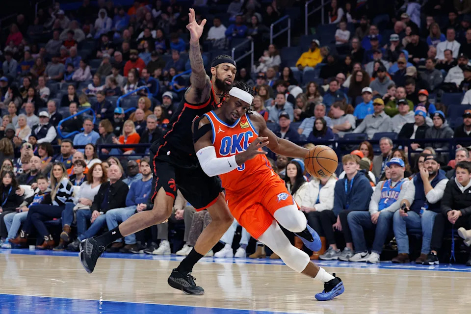 Jan 25, 2026; Oklahoma City, Oklahoma, USA; Oklahoma City Thunder guard Luguentz Dort (5) drives to the basket as Toronto Raptors forward Brandon Ingram (3) defends during the second quarter at Paycom Center. Mandatory Credit: Alonzo Adams-Imagn Images