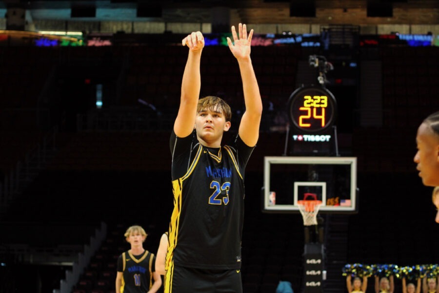 a young man standing on top of a basketball court