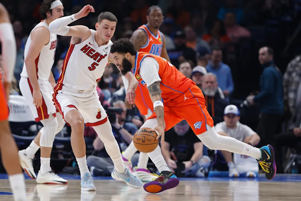 Jan 11, 2026; Oklahoma City, Oklahoma, USA; Oklahoma City Thunder guard/forward Kenrich Williams (34) drives to the basket around Miami Heat forward Nikola Jović (5) during the second quarter at Paycom Center. Mandatory Credit: Alonzo Adams-Imagn Images