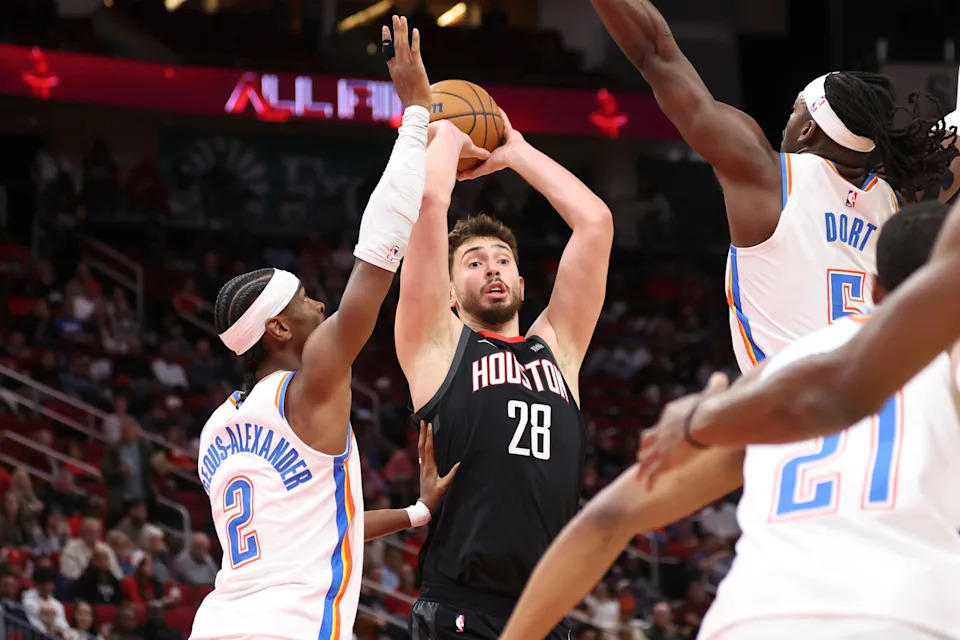 Jan 15, 2026; Houston, Texas, USA; Houston Rockets center Alperen Sengun (28) looks to pass the ball as Oklahoma City Thunder guard Shai Gilgeous-Alexander (2) defends during the first quarter at Toyota Center. Mandatory Credit: Troy Taormina-Imagn Images
