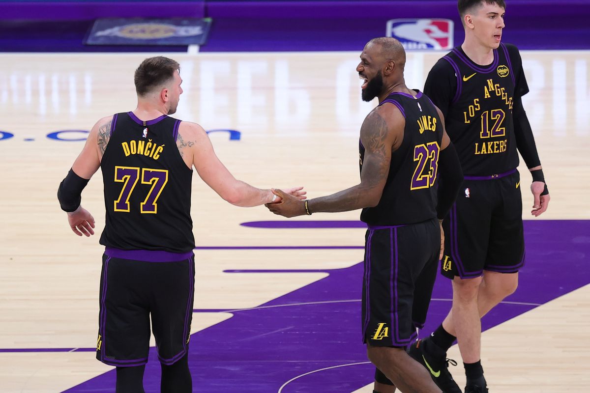 #23 SF LeBron James and #77 PG Luka Doncic of the Los Angeles Lakers embrace during an NBA game against the Memphis Grizzlies on January 2, 2026 in Los Angeles, CA.