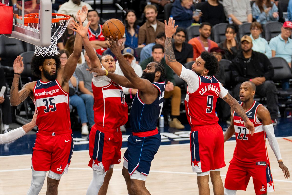 Los Angeles Clippers guard James Harden (1) attempts a lay up over three defenders during an NBA basketball game against the Washington Wizards, Wednesday January 14th, 2026 in Los Angeles, California.